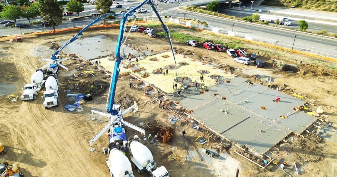 Concrete crew finishing a foundation slab